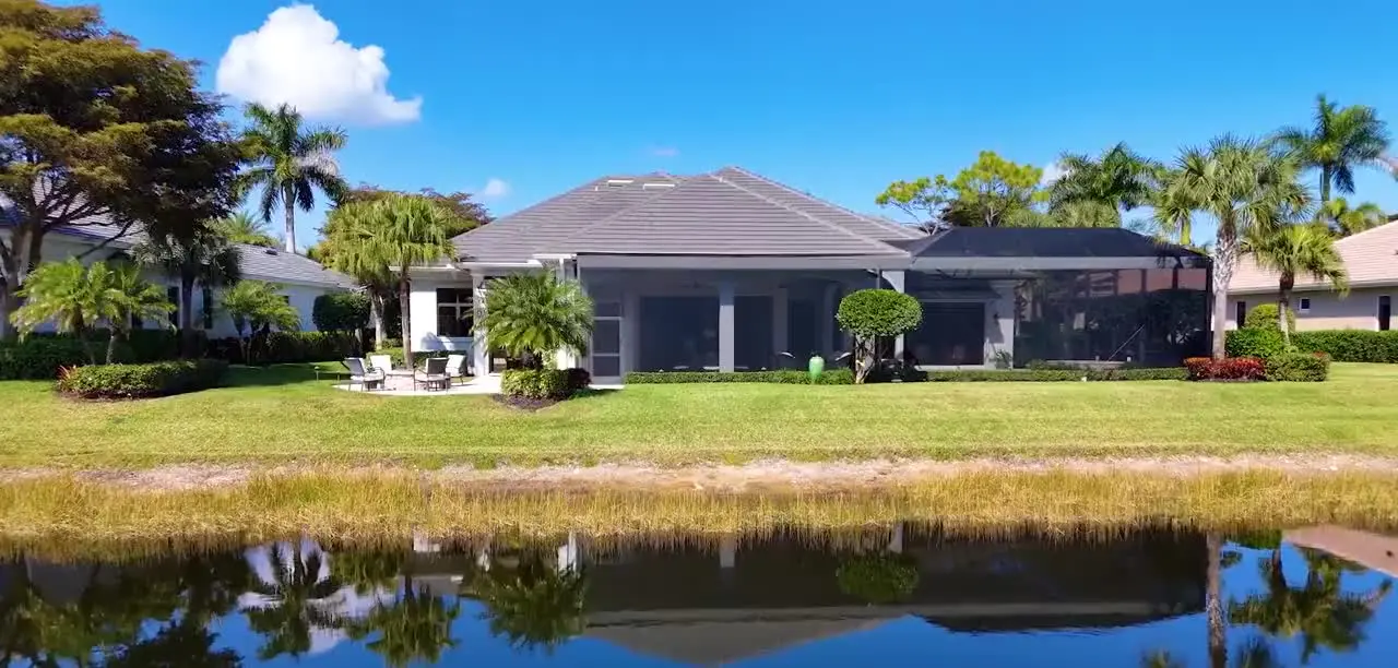 Frame from a property film showing a lakeside home and its reflection